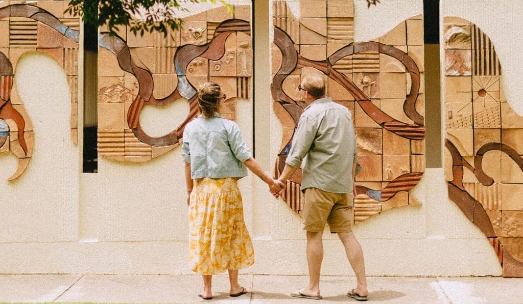 Young couple admiring wall mural artwork