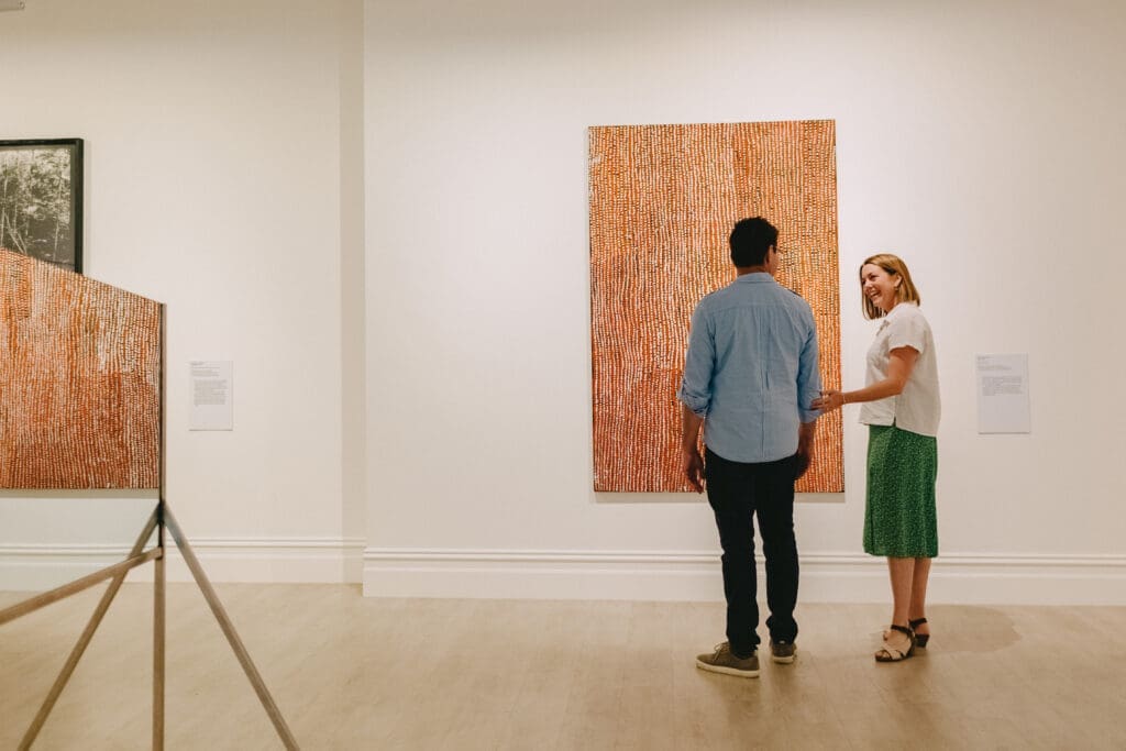 Couple admiring artwork at Murray Art Museum Albury (MAMA)