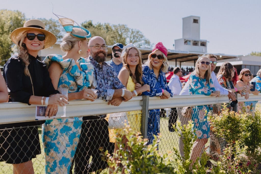 A group of well dressed punters stand trackside at the Commercial Club Albury Gold Cup Carnival.