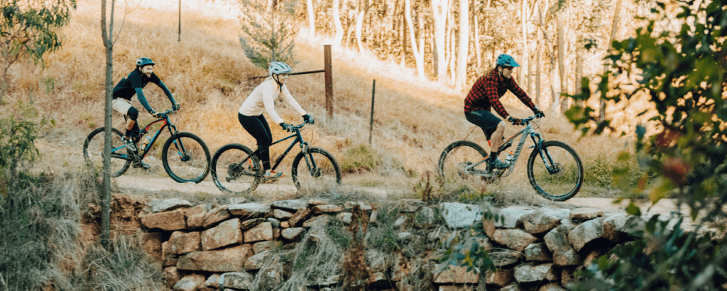 Three people riding mountain bikes at McFarlanes Hill, Wodonga