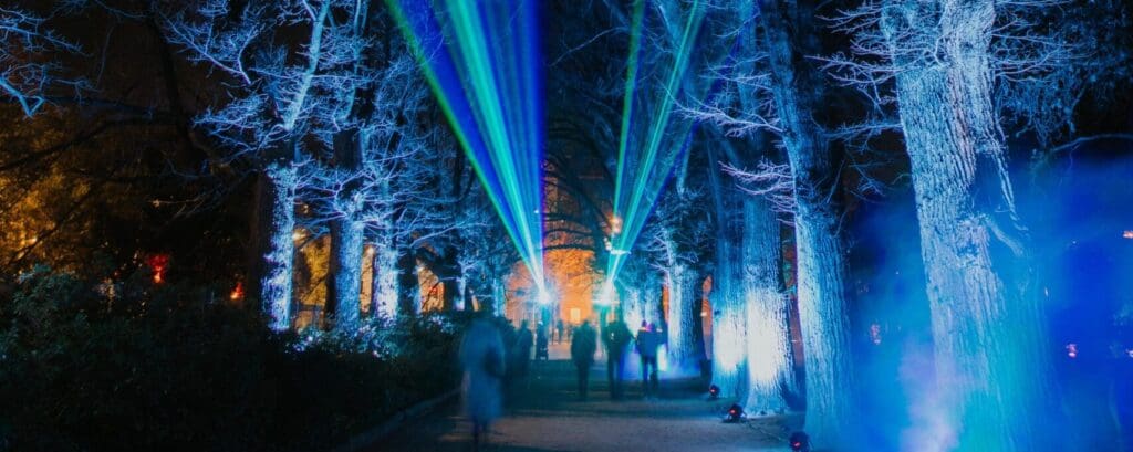 Bright lights and coloured lamps highlight a garden, part of the Aurora luna sound and light show