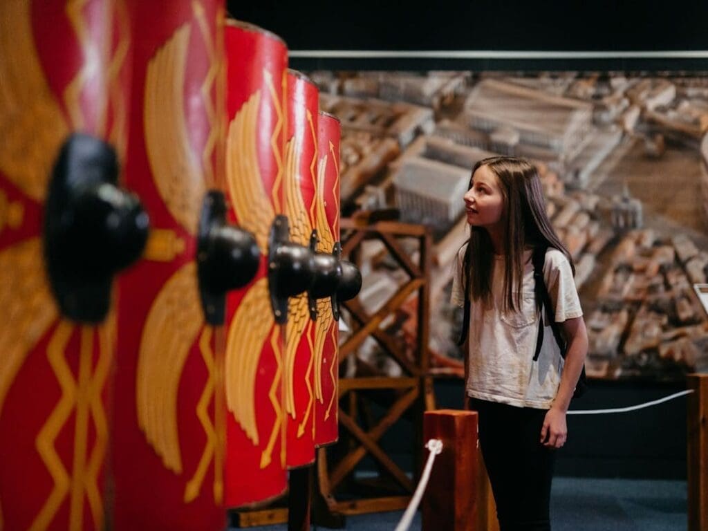 A girl looks at a display part of the Ancient Rome touring exhibition