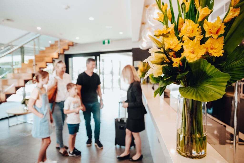 A family are in the reception area, checking into the Quest Wodonga hotel